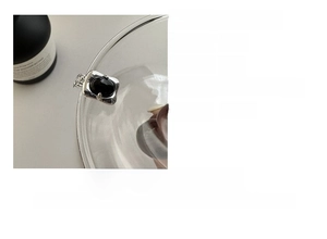 Macro detail of S925 sterling silver square pendant necklace with black agate stone inlay