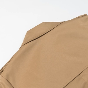 Detail of khaki trench coat collar and shoulder stitching with fine twill texture