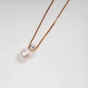 Classic white freshwater pearl necklace with sparkling zircon pendant on gold chain