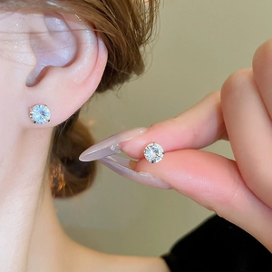 Minimalist silver stud earrings with round cubic zirconia in a classic four-claw setting