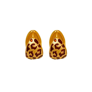 U-shaped golden earrings with brown leopard print enamel pattern on white background
