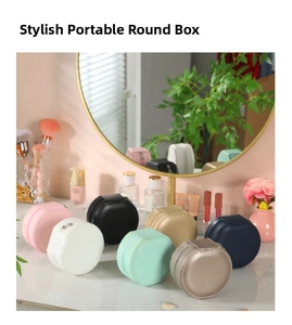 Compact round travel jewelry case set in assorted colors with zip closure and faux leather