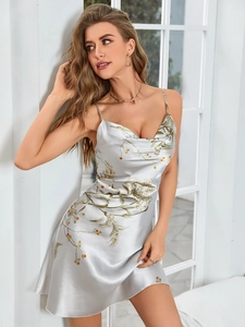 Detail of silk satin nightdress featuring elegant floral prints and draped neckline