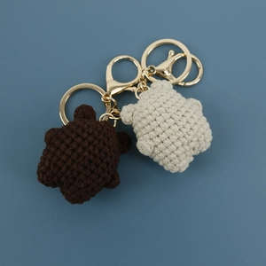 Handmade crochet star keychains in brown and cream white with golden metal rings