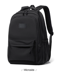 Detailed front view of black nylon backpack with padded straps and large front pocket