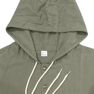 Detail of army green linen shirt collar with buttons, drawstring, and size label