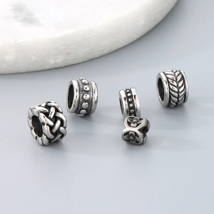 Macro shot of titanium steel spacer beads with various vintage engraved patterns for DIY