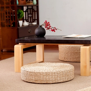 Handcrafted round straw tatami cushion in a minimalist Japanese home setting