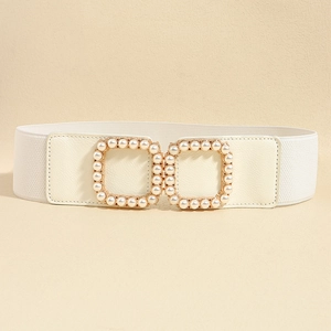 Detail view of a white elastic waist belt with pearl-embellished square buckles on leather