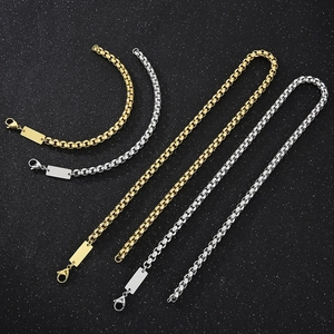 Detail of gold and silver stainless steel box chains with rectangular pendant tags