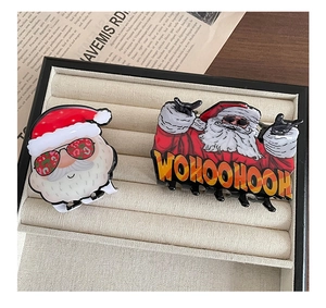 Detail of Christmas hair claws with cool Santa wearing sunglasses in a gift box