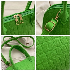 Macro details of green felt shell bag with crocodile texture and gold hardware zipper