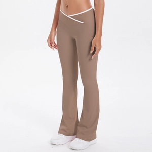 Detail of high-waisted cross-over waistband and flared brown yoga pants fit for sports