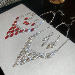 Sparkling diamond-encrusted oval tassel necklace and earring sets in red and champagne