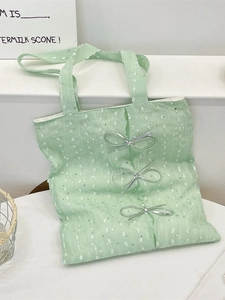 Mint green sequined tote bag with silver bows and vertical floral lace patterns