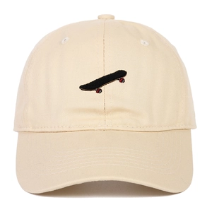 Classic beige cotton baseball cap featuring detailed skateboard embroidery on the front