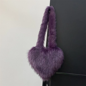 Detailed view of the soft purple faux fur texture on a heart-shaped plush handbag