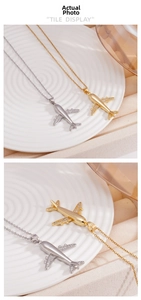 Macro detail of gold and silver airplane pendants with pave-set shimmering crystals