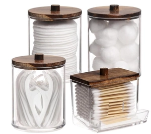 Set of four clear acrylic jars with dark wooden lids for cotton pads and swab storage