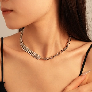 Detail of asymmetric rhinestone chain necklace with polished silver-tone metal links