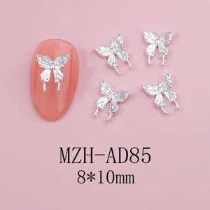 Detailed macro view of silver hollow butterfly nail charms sized 8x10mm for manicures