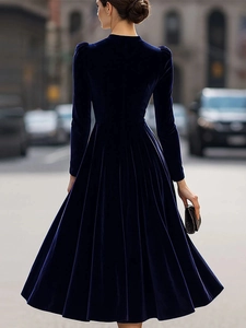 Back view of a navy blue velvet dress with long sleeves and elegant flared waist
