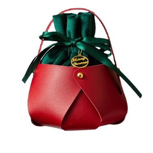 Red leather Christmas gift bag with green velvet drawstring and Merry Christmas gold tag