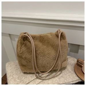 Close-up of khaki plush shoulder bag with fluffy texture and faux leather strap