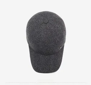Top-down view of men's winter baseball cap showing textured wool fabric and metal logo detail