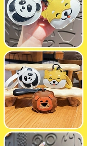 Detail of leather cartoon animal keychains featuring panda and shiba inu bag charms