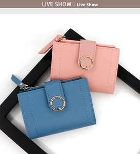 Close-up of pink and blue short wallets featuring gold ring buckles and zipper details