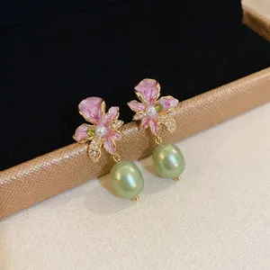 Gold-plated floral orchid earrings with pink enamel and green baroque pearl drops