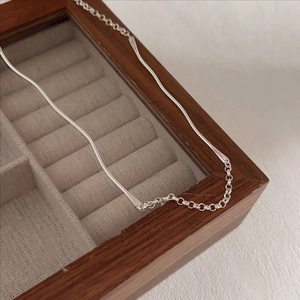 Minimalist S925 sterling silver wavy bar necklace on elegant wooden jewelry box