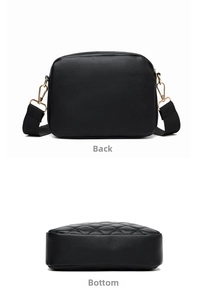 Detail view of the black crossbody bag showing its quilted bottom and back panel texture