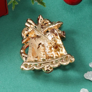 Macro view of the secure pin closure on the back of a festive gold Christmas bell brooch