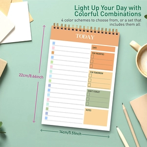 Flat lay of daily schedule planner with color-coded sections and metal spiral binding