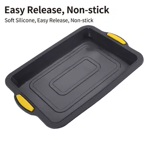 Rectangular gray silicone brownie baking pan with yellow non-stick handles