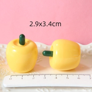 Detailed size view of yellow 2.9x3.4cm resin apples for DIY crafts and decor