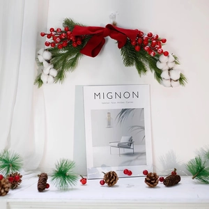 Christmas pinecone swag with red velvet bow and cotton flowers for home holiday decor