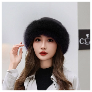 Close-up of black faux fur winter hat texture and plush material on female model