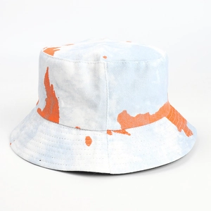 Close-up of tie-dye bucket hat showing cotton texture and orange marble pattern detail