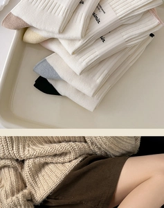 Detail view of cotton mid-calf socks showing knit texture and colorful heel accents