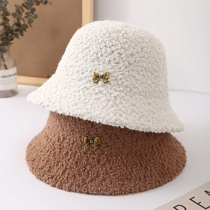 Plush lamb wool bucket hats for women with elegant golden bow metal accent