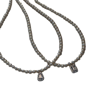 French vintage freshwater pearl necklace featuring teardrop and radiant cut zircon pendants