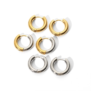 Polished stainless steel hoop earrings in gold, silver and mixed tones on white surface