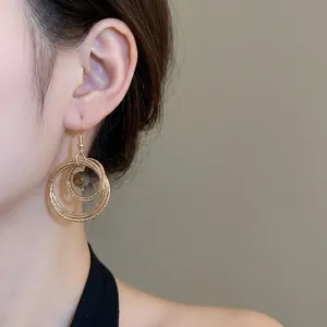 Tiger eye stone gold hoop earrings with multi-layered circular design and bead detail