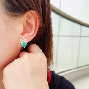 Floral stud earrings with green emerald zircon and marquise diamonds on gold base