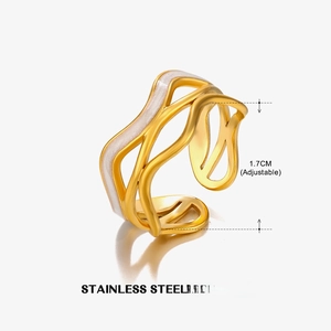 Close-up of wave-shaped gold ring with white enamel detail and 1.7cm adjustable size mark