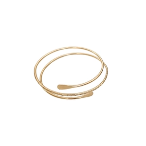Minimalist gold multi-layer wrap ring with handcrafted hammered texture and smooth finish