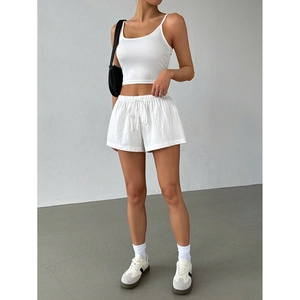 Close-up of a women's white summer lounge set with a strapless top and drawstring shorts